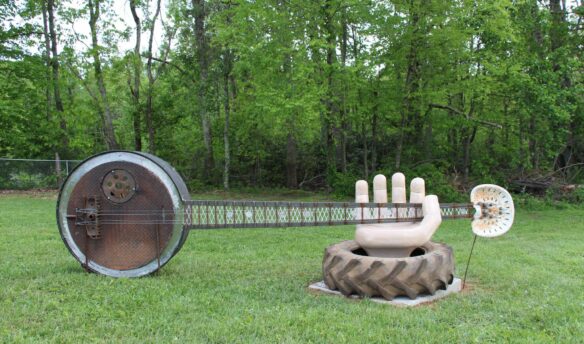 Statue of a hand holding a banjo.